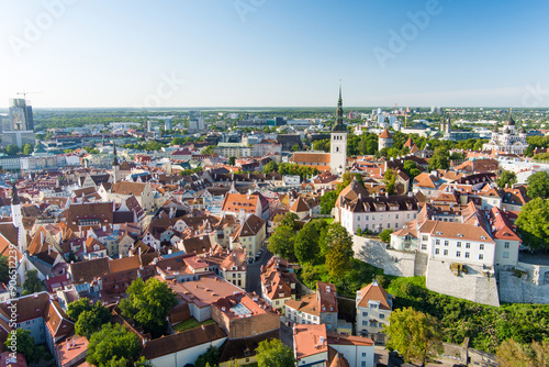 Iconic aerial skyline view of Tallinn Old Town and Toompea hill on a sunny summer evening. Stenbock House, Patkuli viewing platform, defensive walls, rooftops.