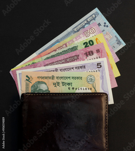 Bangladeshi money in a wallet on black background photo