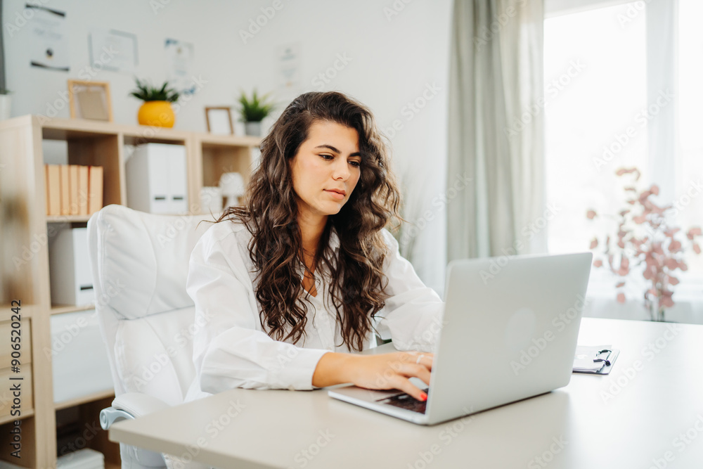 Young caucasian business woman working in office on laptop Young caucasian business woman working in office on laptop