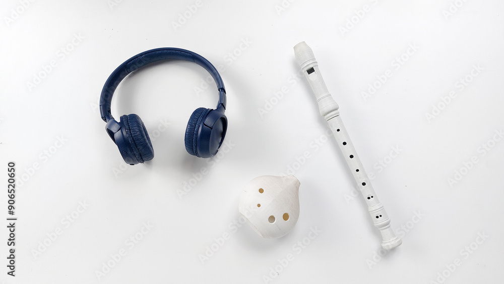 Musical instruments on a white background. Recorder , ocarina and headset Musical instruments on a white background. Recorder , ocarina and headset