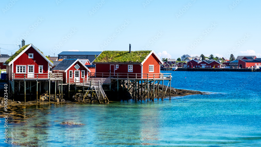 Charming Red Cabins Overlooking the Calm Waters of Norway’s Scenic Coast, Reine Lofoten Norway Charming Red Cabins Overlooking the Calm Waters of Norway’s Scenic Coast, Reine Lofoten Norway