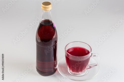 Non-alcoholic drink in bottle and cup of fruit drink