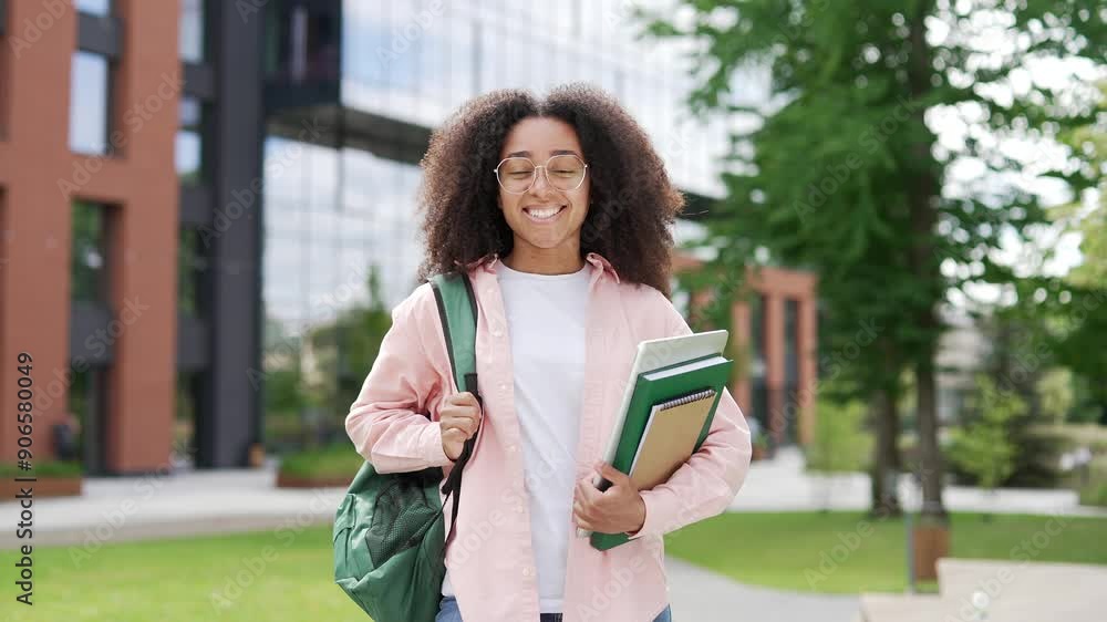 Portrait of smiling african american female student in glasses with ...