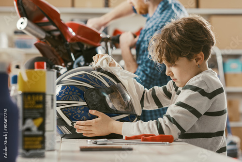 фотографія Happy boy helping his father in the garage