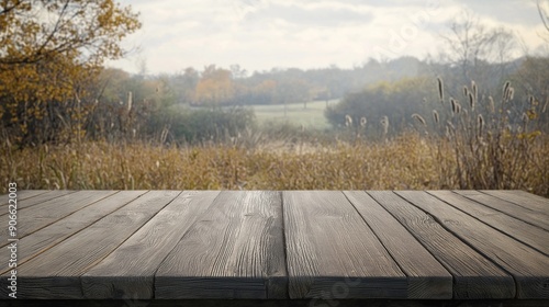 Rustic wooden table stands alone in golden autumn field with endless sky
