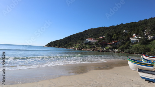 Wooden boats on the sand in a sunny day on Praia da Lagoinha da Ponta das Canas, Florianópolis, Santa Catarina, Brasil.