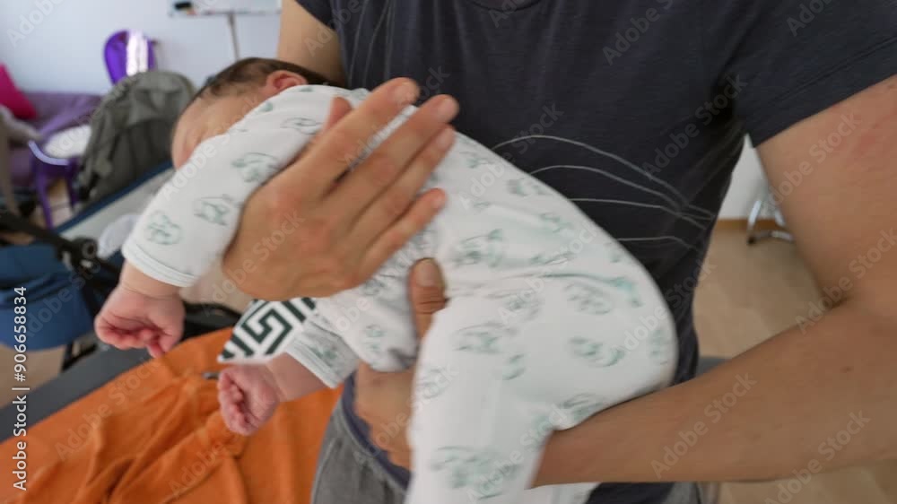 Orthopedist supporting newborn in a unique position to relieve body pains during early childhood. baby is in a cozy onesie, showcasing the care and professional treatment provided Orthopedist supporting newborn in a unique position to relieve body pains during early childhood. baby is in a cozy onesie, showcasing the care and professional treatment provided