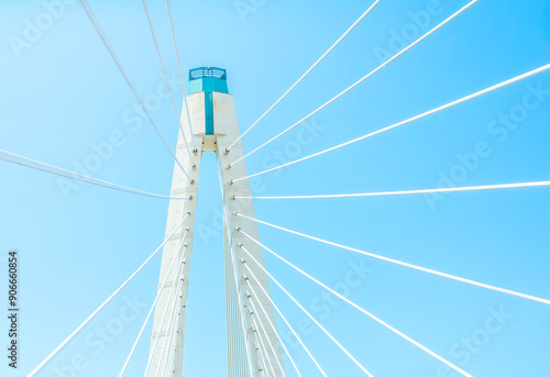 Part of a large white cable-stayed bridge against a blue sky in St. Petersburg photo