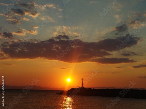 Cloudy orange sunset over the Messinian Bay in Greece photo