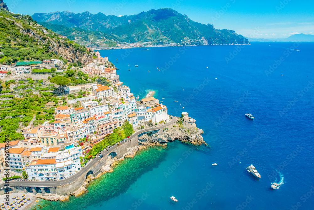 Naklejka premium Amalfi on Amalfi Coast, Italy. Aerial photo of famous city Amalfi located on Amalfi Coast with blue sea water and beautiful colorful houses on the cliff