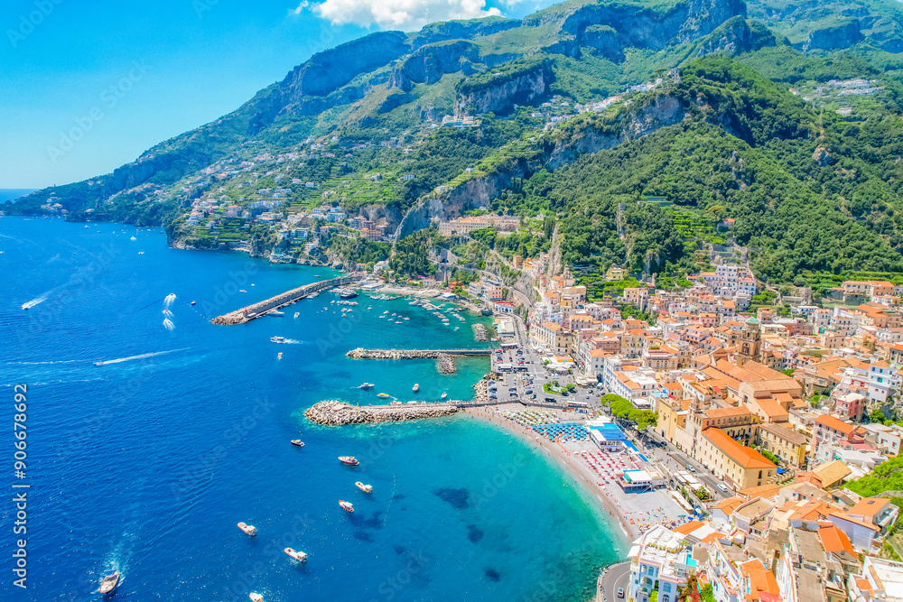 Naklejka premium Amalfi on Amalfi Coast, Italy. Aerial photo of famous city Amalfi located on Amalfi Coast with blue sea water and beautiful colorful houses on the cliff