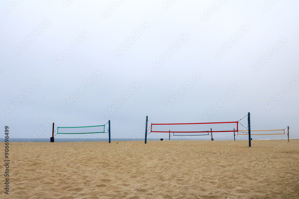 Colorful nets of volleyball courts at South Mission beach covered with morning ocean fog, San Diego, California Colorful nets of volleyball courts at South Mission beach covered with morning ocean fog, San Diego, California