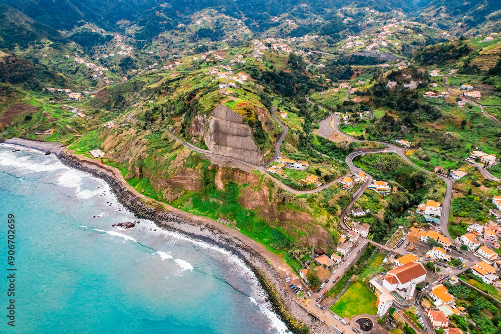 Obraz premium Aerial view of rough ocean with waves, volcanic beach in Porto da Cruz, Madeira, Portugal