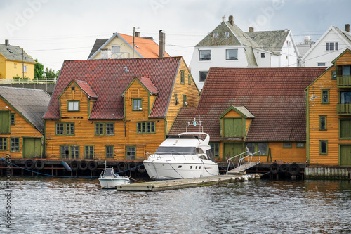 Quaint wooden buildings and boats on the harbourside of the Norwegian town of Haugesund photo