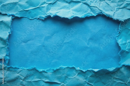 Ripped blue paper with rough edges creating a textured and dynamic visual, perfect for creative projects and artistic backgrounds. photo