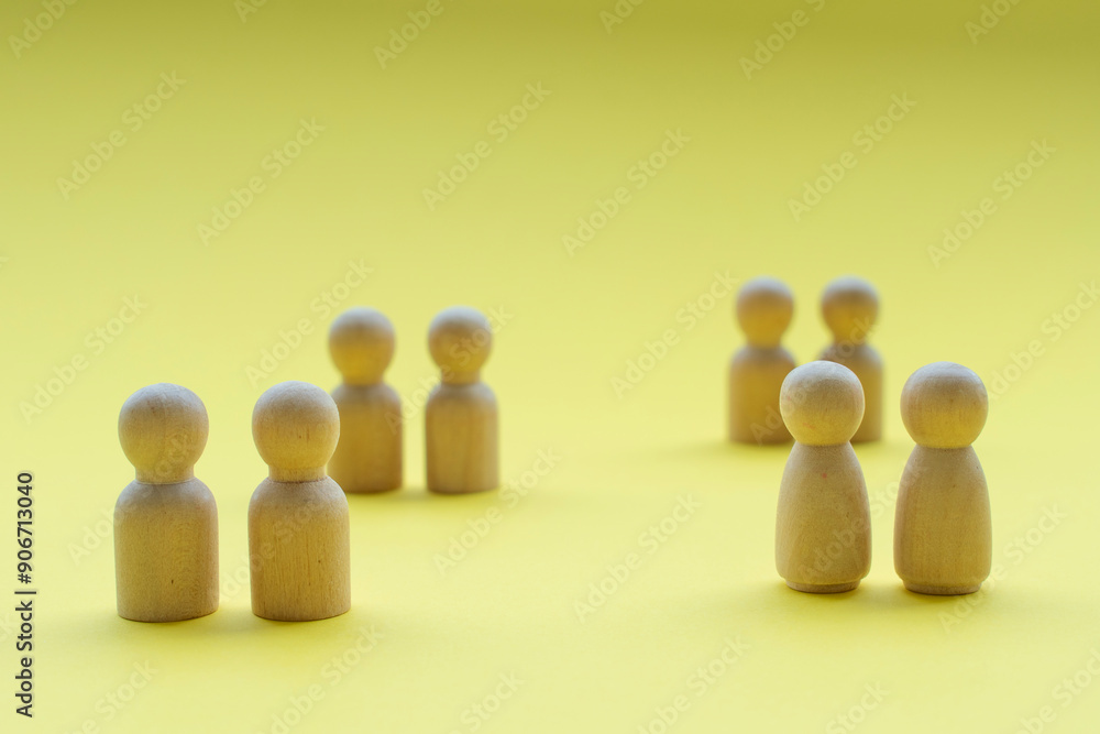 Wooden figures on yellow cover background with customizable space for text Wooden figures on yellow cover background with customizable space for text