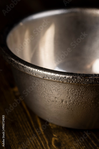 a shiny metal plate covered with water droplets photo