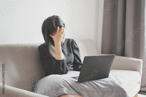 Billede på lærred Stressed young asian woman suffering the neck pain and head ache while working w