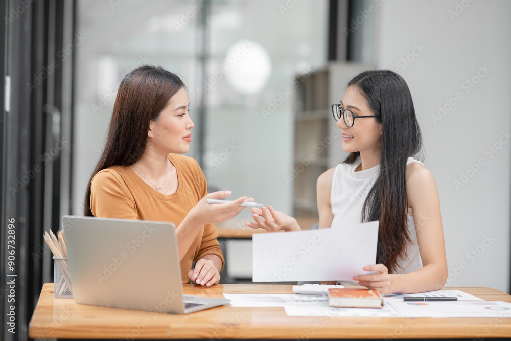 Asian business woman Discussing business documents in the office
Asian business woman Discussing business documents in the office