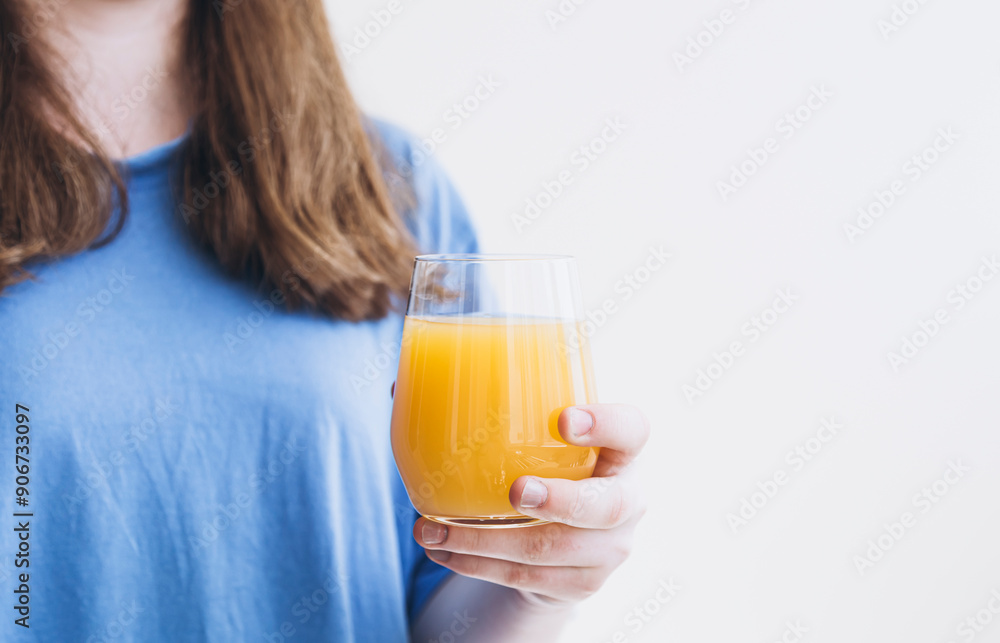 Glass of orange juice in hands on white background isolated, copy space. Glass of orange juice in hands on white background isolated, copy space.