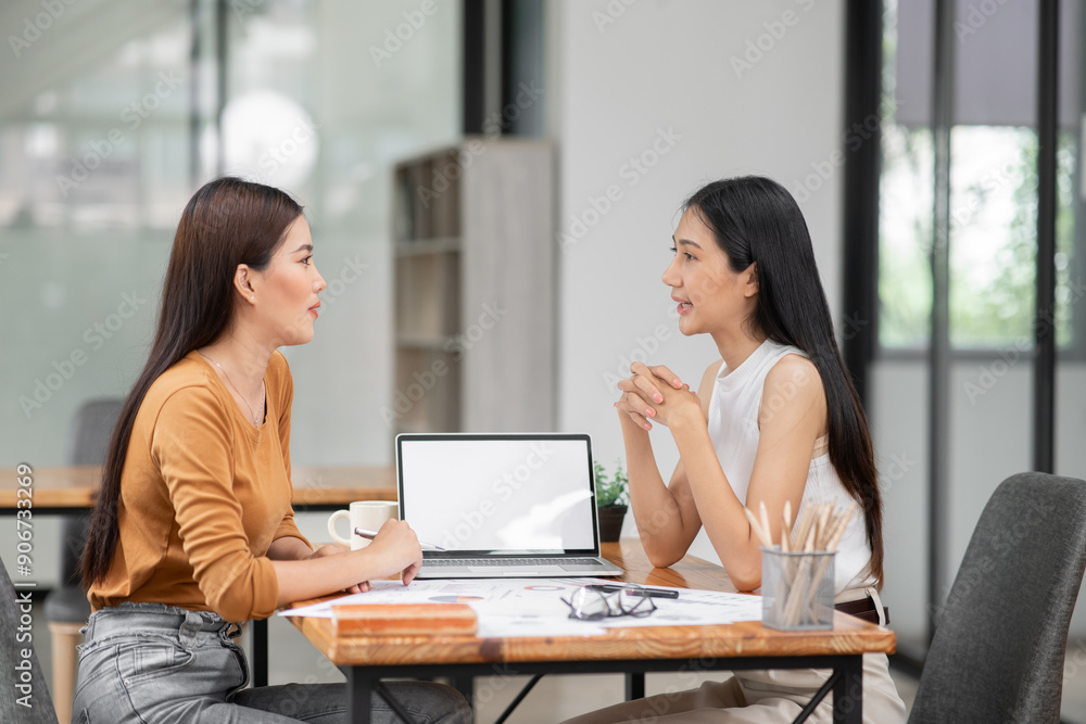 Group of Asian business and women sitting and looking at documents at the office. Group of Asian business and women sitting and looking at documents at the office.