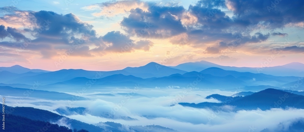 Fototapeta premium Mountain Ranges Covered in Fog with a Pink and Blue Sky