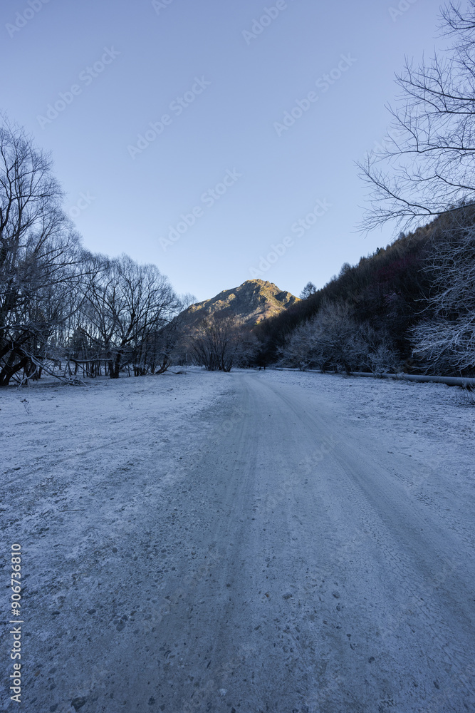 Snowy walking track with a mountain view in the background. Snowy walking track with a mountain view in the background.