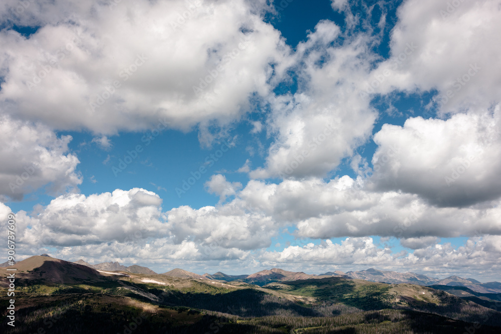 The shadows from the billowing clouds overhead dance across the Rocky Mountains in Rocky Mountain National Park, Colorado in mid-August The shadows from the billowing clouds overhead dance across the Rocky Mountains in Rocky Mountain National Park, Colorado in mid-August