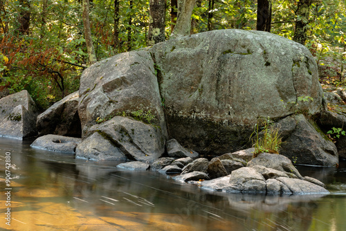 Large boulders line the shorelilne above the upper falls at Dave's Falls County Park, Marinette County, Amberg, Wisconsin as the Pike River races alongside.