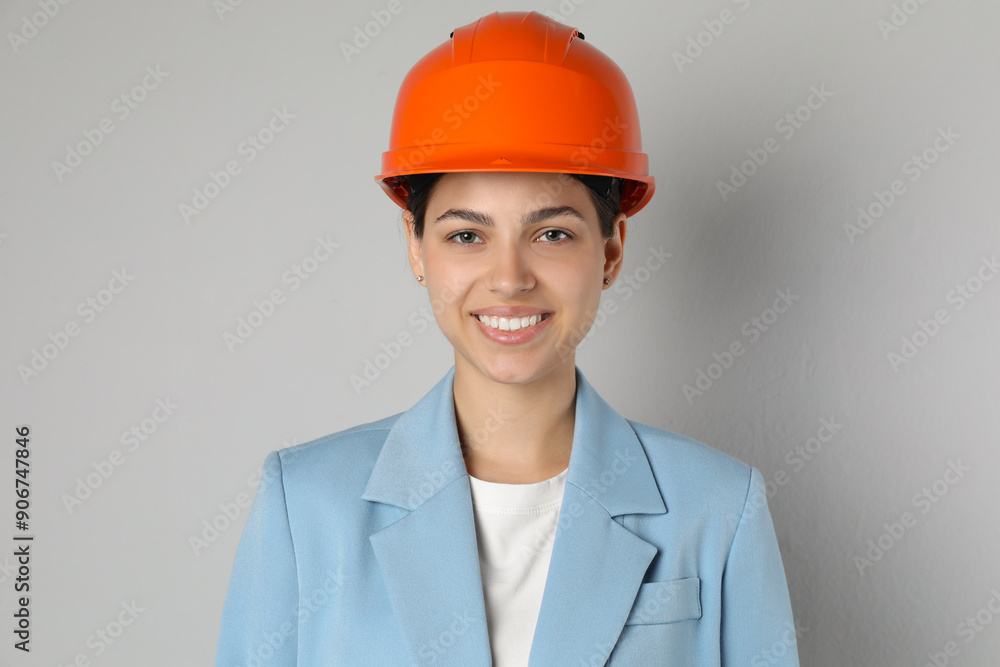 Engineer in hard hat on grey background Engineer in hard hat on grey background