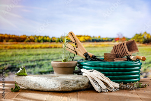 Wallpaper Mural Garden tools and stone flat pedestal with empty copy space for products. Wooden table and autumn landscape  background. Torontodigital.ca