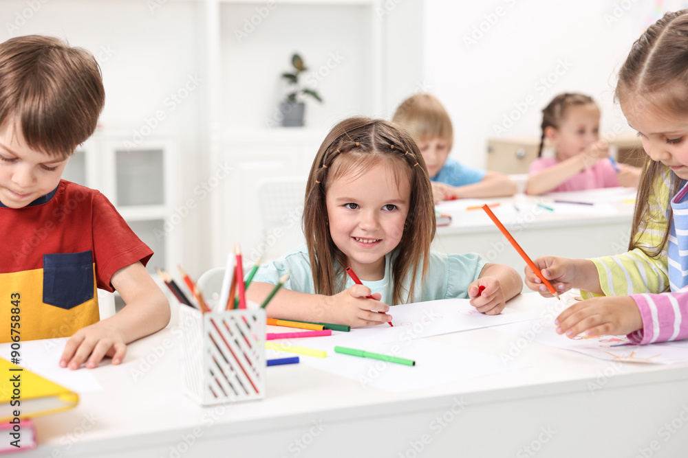 Group of children drawing at table indoors Group of children drawing at table indoors