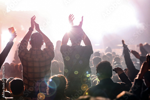 Audience enjoys music concert. An epic neon light party. People clap.
