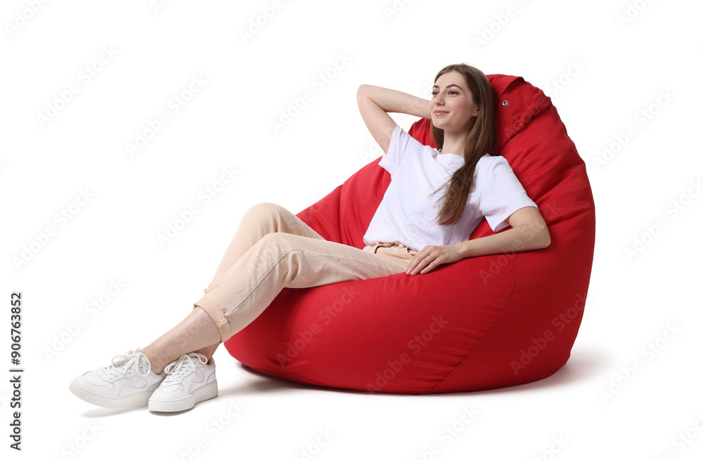 Beautiful young woman sitting on red bean bag chair against white background Beautiful young woman sitting on red bean bag chair against white background