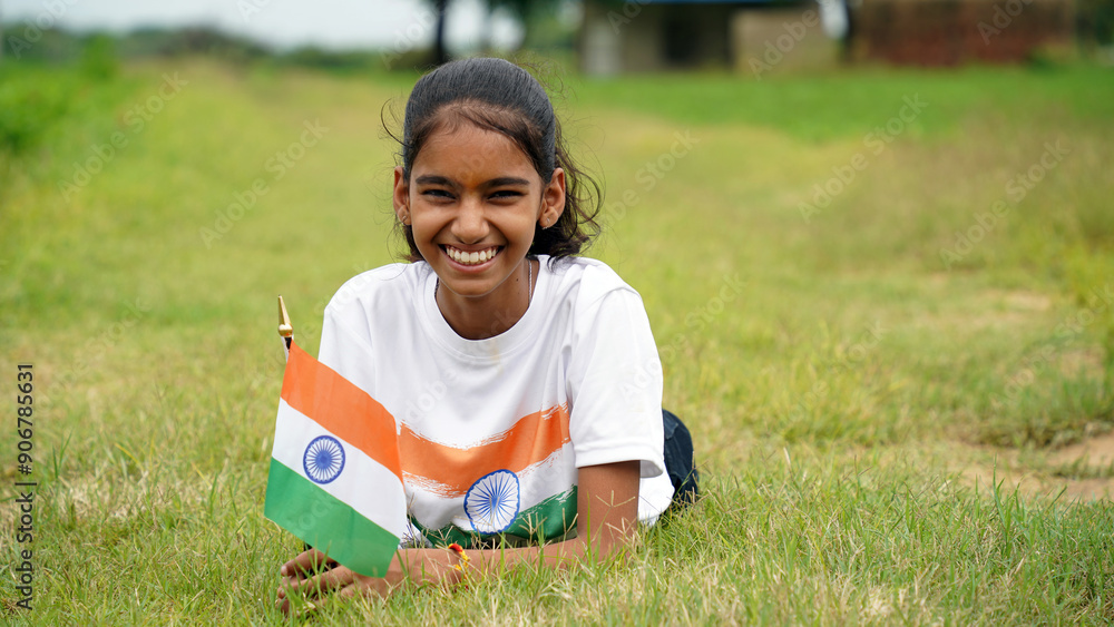 Cute indian little smiling girl waving national tricolor flag at agriculture field. Cute indian little smiling girl waving national tricolor flag at agriculture field.