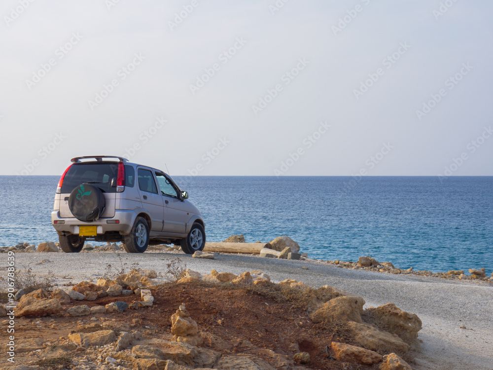 Off-roader jeep standing and resting on a lonely shore of calm Mediterranean sea in Ayia Napa, Cyprus. Marine view.
