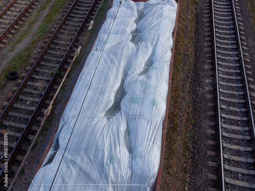 Obraz na płótnie Top view over a freight train wagon without a roof loaded with huge white sacks and waiting at the station in Kyiv city, Ukraine. w salonie