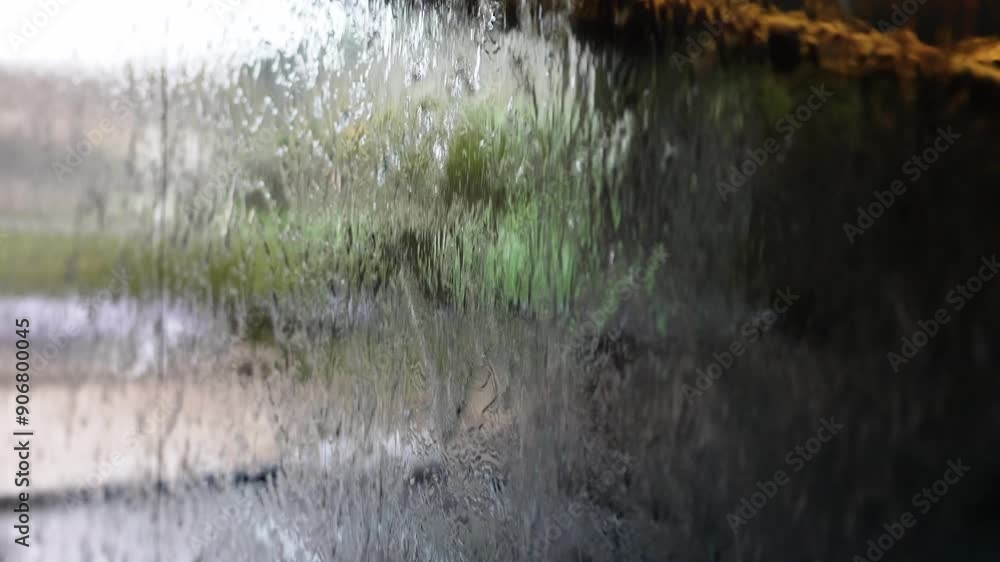 The waterfall and glass wall background. Meditation concept. Flow of water. Piece. The waterfall and glass wall background. Meditation concept. Flow of water. Piece.