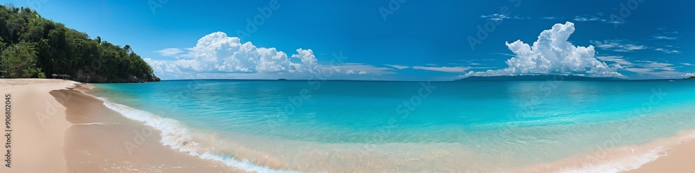 A beautiful beach with a clear blue ocean and a few clouds in the sky A beautiful beach with a clear blue ocean and a few clouds in the sky