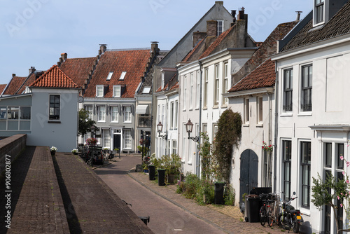 Narrow street along historic monumental buildings in the fortified town of Wijk bij Duurstede. photo