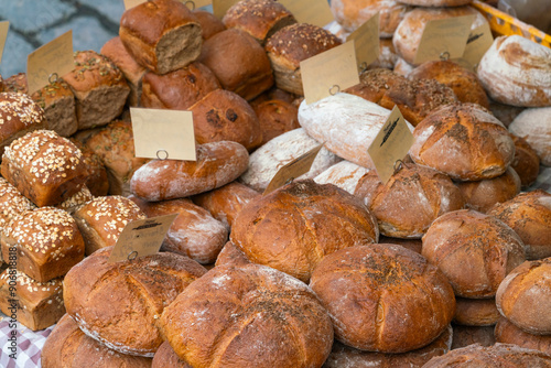 Different types of fresh bread on display at farmers market on Vltava riverside near Palackeho namesti, Prague, Czech Republic (Czechia), Europe photo