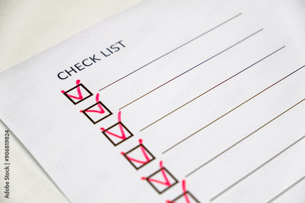 checklist with red check marks on paper checklist with red check marks on paper