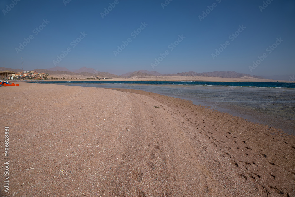 Sandy beach on the seashore. Desert at sunset. Yellow sand. Beautiful sky. Sandy beach on the seashore. Desert at sunset. Yellow sand. Beautiful sky.