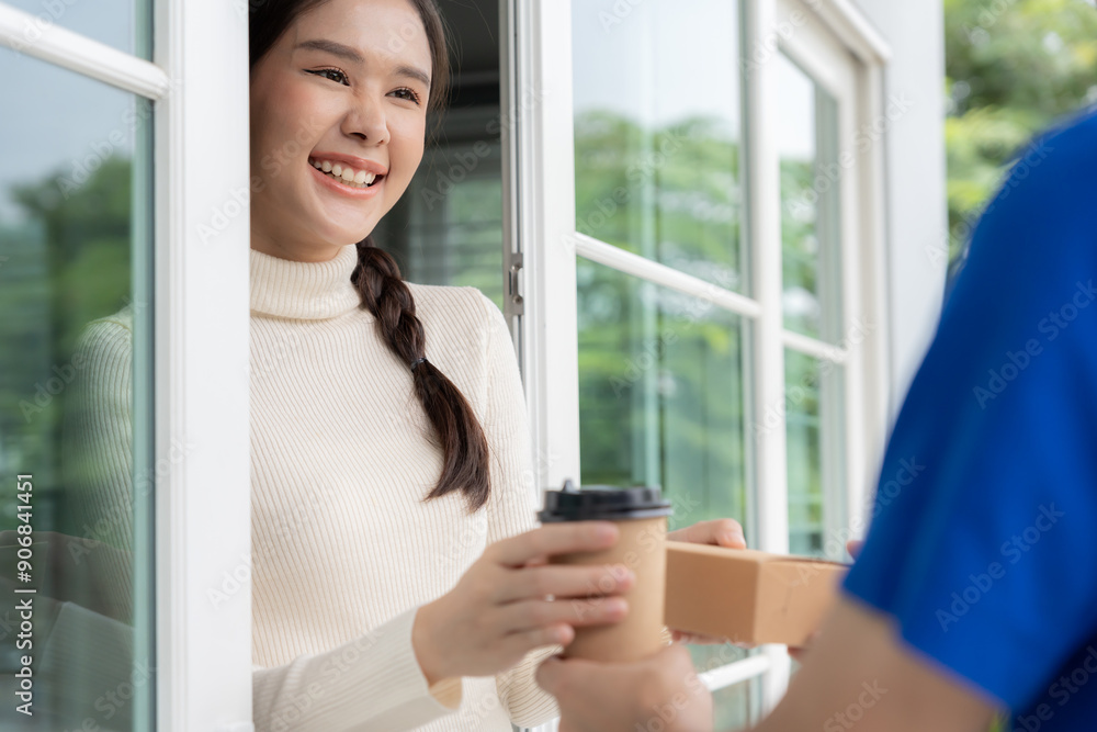 Happy smiling Asian woman receives paper box parcel of food from courier front house. Delivery man send deliver express. online shopping, paper container, takeaway, postman, delivery service, packages Happy smiling Asian woman receives paper box parcel of food from courier front house. Delivery man send deliver express. online shopping, paper container, takeaway, postman, delivery service, packages