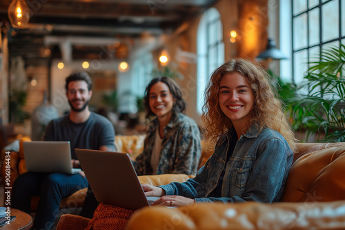 Smiling colleagues working on laptops in a cozy office space