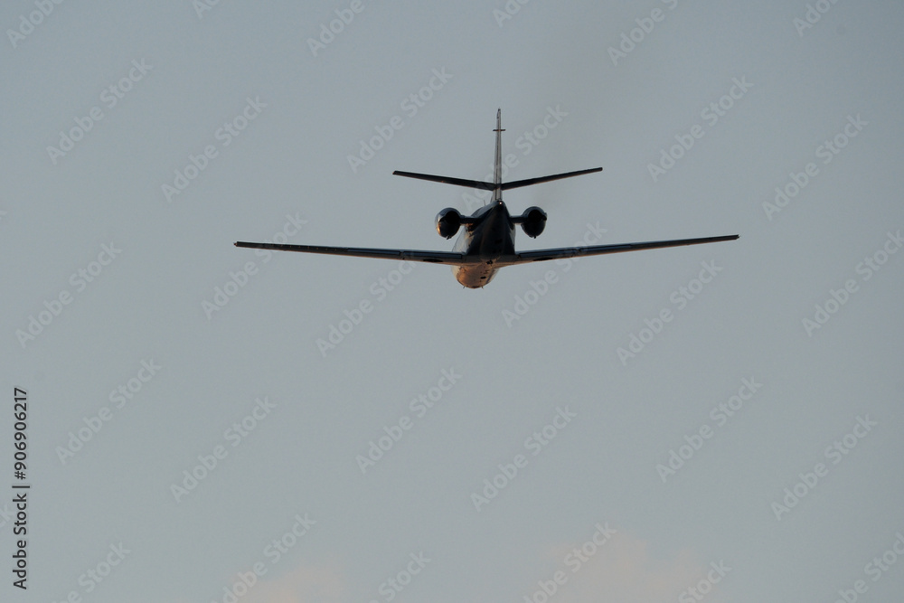 Airplane in the blue sky. Airplane in the sky. Airplane in flight over the blue sky. Traveling concept. Airplane in the blue sky. Airplane in the sky. Airplane in flight over the blue sky. Traveling concept.