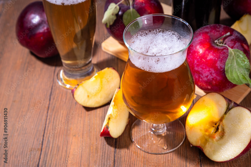 Glasses with Sour Sweet fruit Apple Craft Beer, Cider or Ale on wooden table with fresh red apple slices Glasses with Sour Sweet fruit Apple Craft Beer, Cider or Ale on wooden table with fresh red apple slices