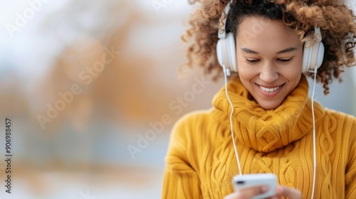 Young Woman Enjoying Music Outdoors in Autumn While Using Smartphone