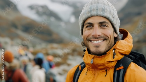 Smiling Hiker in Bright Jacket Against Mountainous Landscape at Dusk