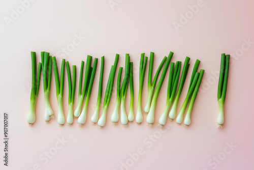 Green onions on ultralight pink background. Minimal concept. Flat lay.  photo